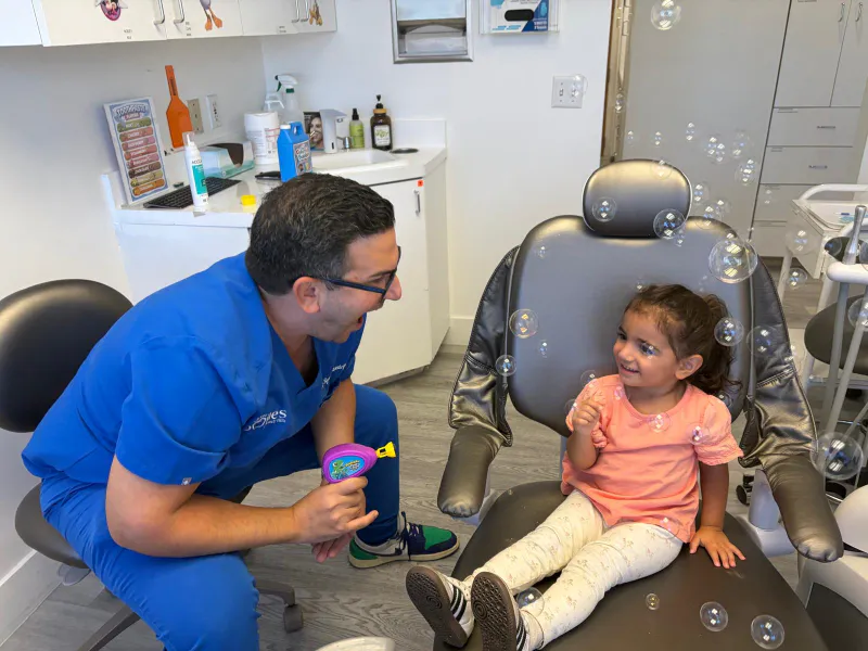 Pediatric dentist Dr. Sepehr Nassiripour restoring a child's tooth with a dental filling