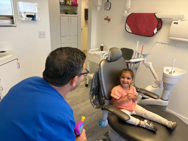 Dr. Sepehr Nassiripour treating a child's tooth at a pediatric dental clinic in Beverly Hills